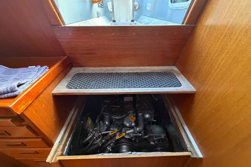 Slide: The Image of Engine compartment of a 1987 Vindo 45 sailboat, showcasing wooden interior design. - 50