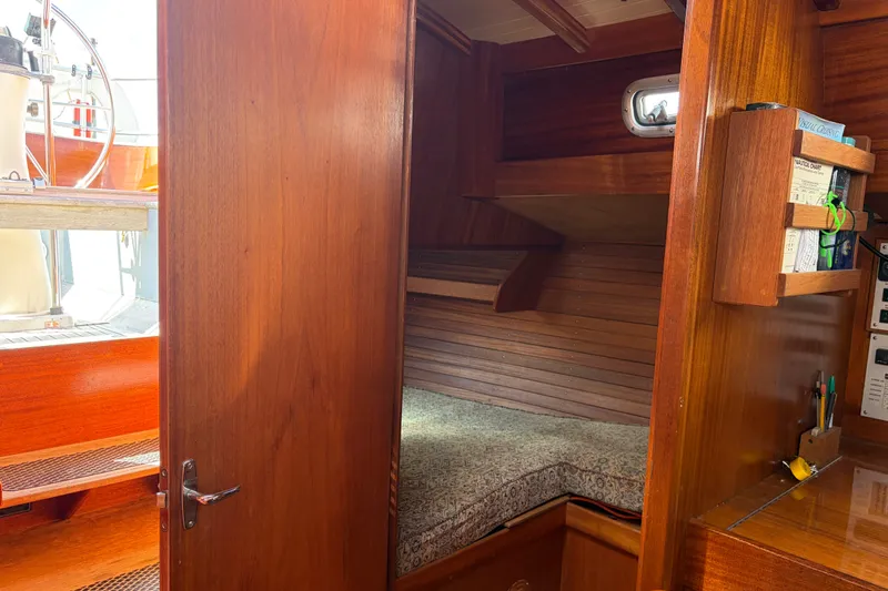 Slide: The Image of Interior of 1987 Vindo 45 sailboat with wooden cabin and cozy sleeping area. - 33