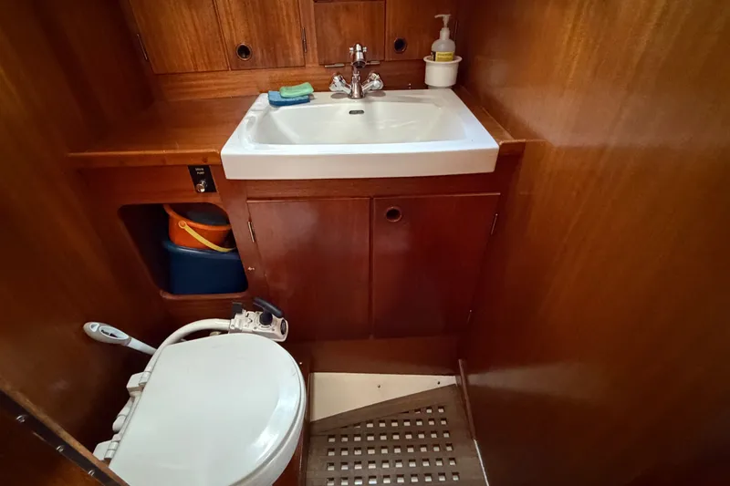 Slide: The Image of Bathroom interior of 1987 Vindo 45 yacht with wooden cabinetry and white fixtures. - 43