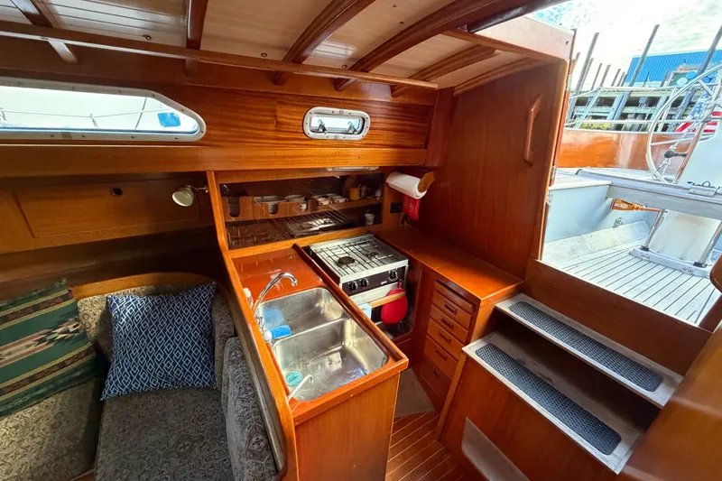 Slide: The Image of Interior of 1987 Vindo 45 sailboat with wooden cabinetry and compact kitchen area. - 30