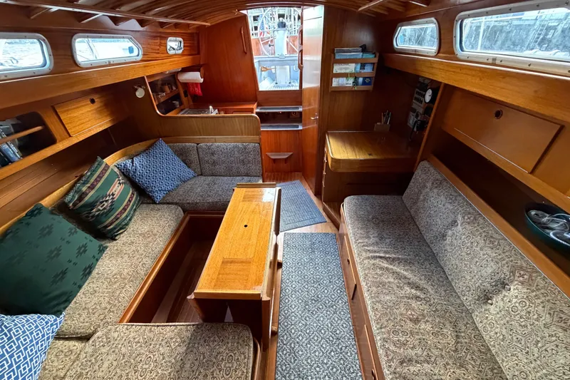Slide: The Image of Cozy interior of 1987 Vindo 45 sailboat with wooden furnishings and patterned cushions. - 35