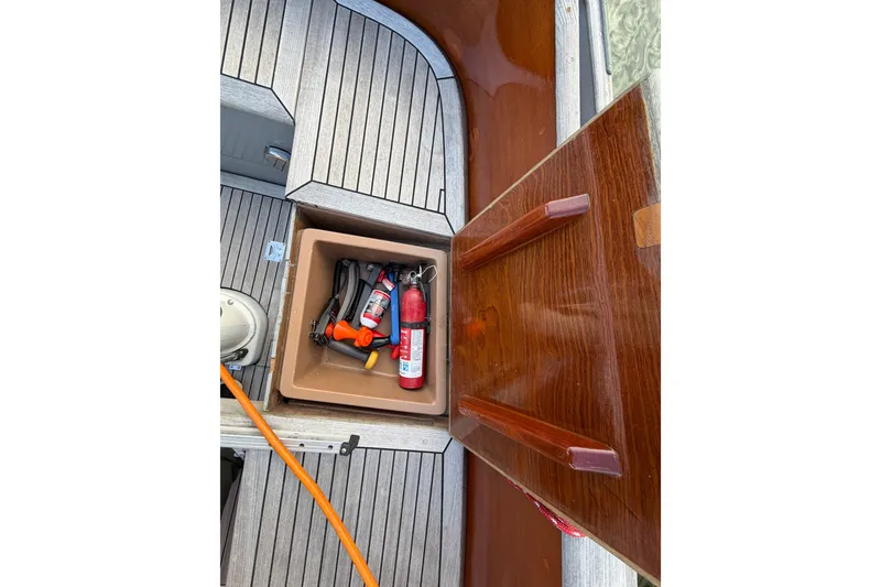 Slide: The Image of Storage compartment on 1987 Vindo 45 boat with tools and fire extinguisher. - 53