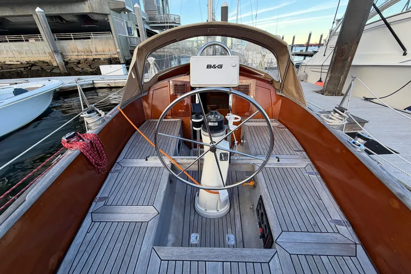 Slide: The Image of Cockpit of 1987 Vindo 45 sailboat with wooden deck and steering wheel at marina. - 22