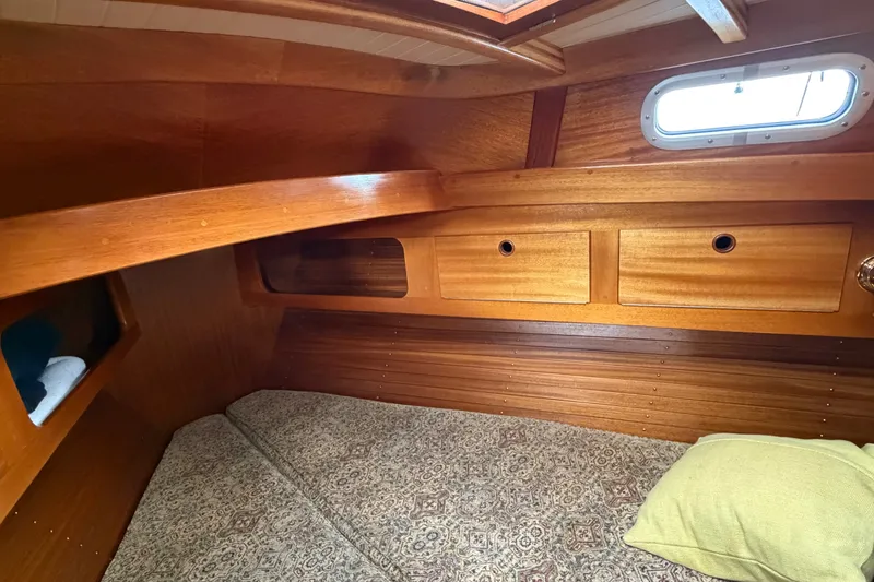 Slide: The Image of Cozy wooden cabin interior of 1987 Vindo 45 sailboat with bed and storage. - 48