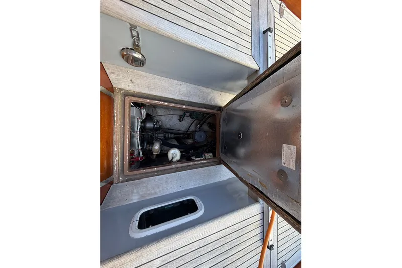 Slide: The Image of Open engine compartment of 1987 Vindo 45 sailboat, showcasing mechanical components. - 52