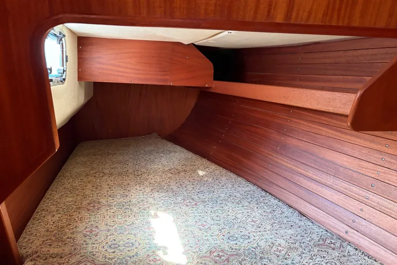 Slide: The Image of Interior cabin of 1987 Vindo 45 sailboat with wooden paneling and patterned carpet. - 34