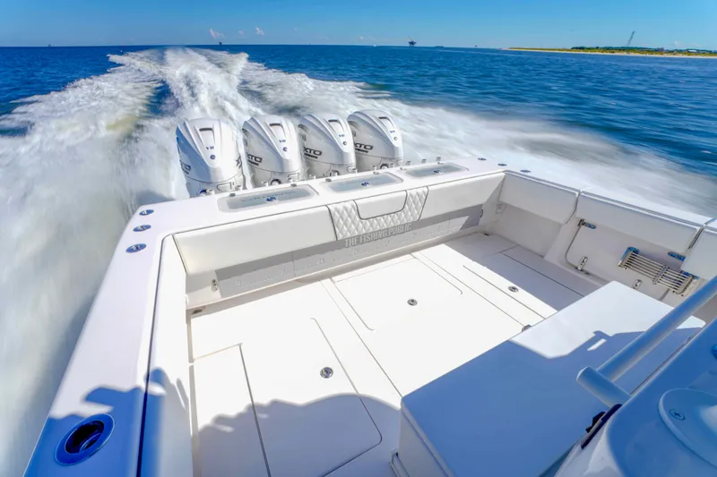Slide: The Image of 2024 Contender 44 CB boat cruising with powerful outboard engines on open water. - 18