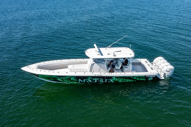 Slide: The Image of 2024 Contender 44 CB boat on open water, featuring sleek design and powerful engines. - 3