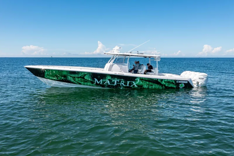 Slide: The Image of 2024 Contender 44 CB boat on open water, featuring sleek design and vibrant graphics. - 4