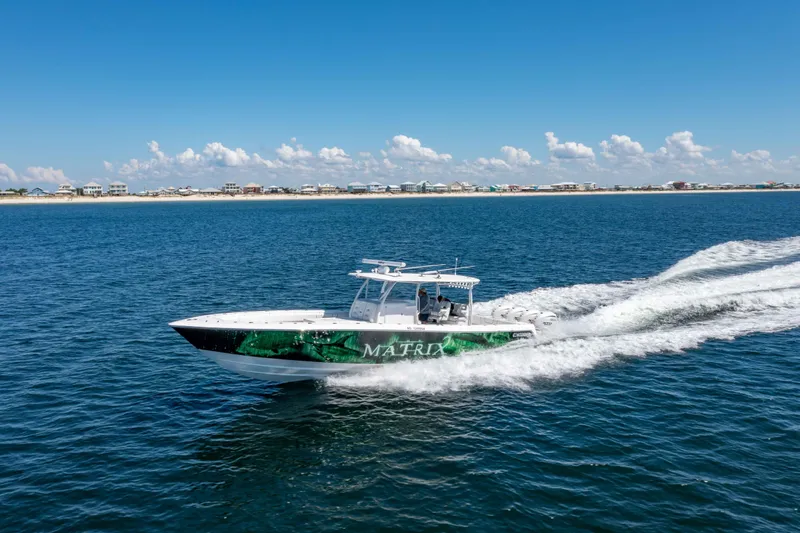 Slide: The Image of 2024 Contender 44 CB boat cruising on open water under clear blue skies. - 6