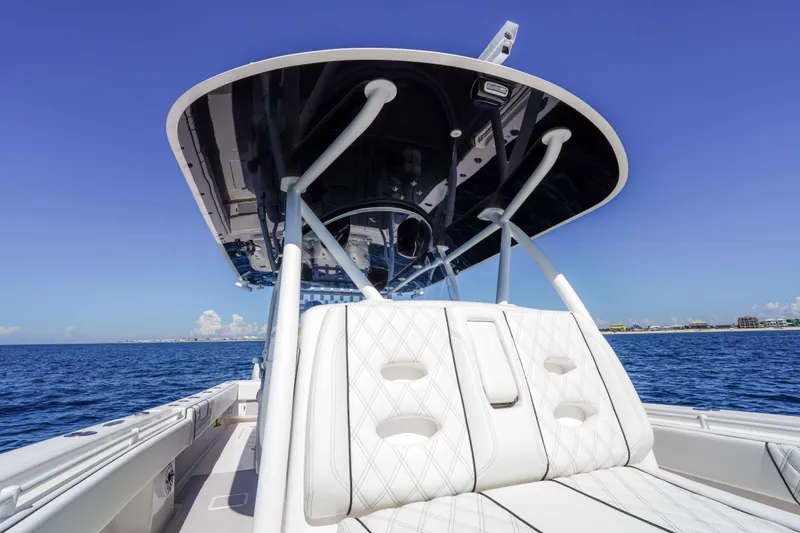 Slide: The Image of 2024 Contender 44 CB boat with sleek design and luxurious seating on open water. - 9