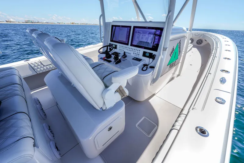 Slide: The Image of 2024 Contender 44 CB boat cockpit with advanced navigation systems and luxurious seating. - 8