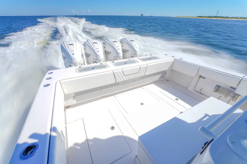 Slide: The Image of 2024 Contender 44 CB boat cruising on open water with powerful outboard engines. - 17