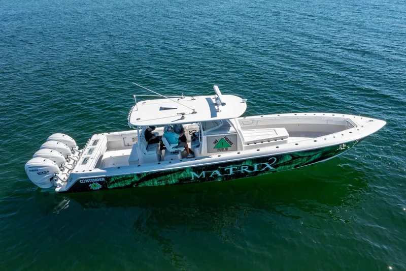Slide: The Image of 2024 Contender 44 CB boat on water, featuring four Yamaha engines. - 2