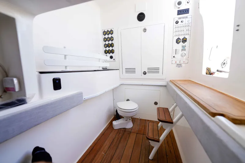 Slide: The Image of 2024 Contender 44 CB cabin interior with wooden flooring and control panels. - 28
