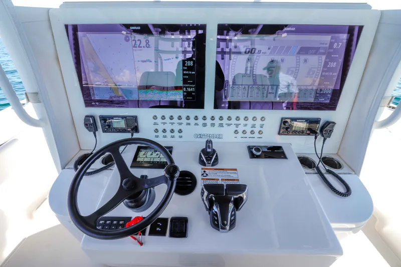 Slide: The Image of 2024 Contender 44 CB helm with dual displays and advanced navigation controls. - 21