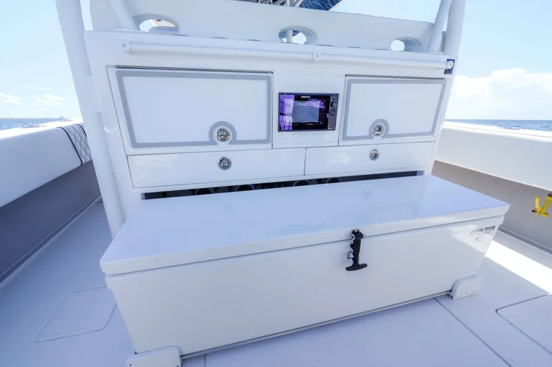 Slide: The Image of 2024 Contender 44 CB boat interior with storage compartments and electronic display. - 7