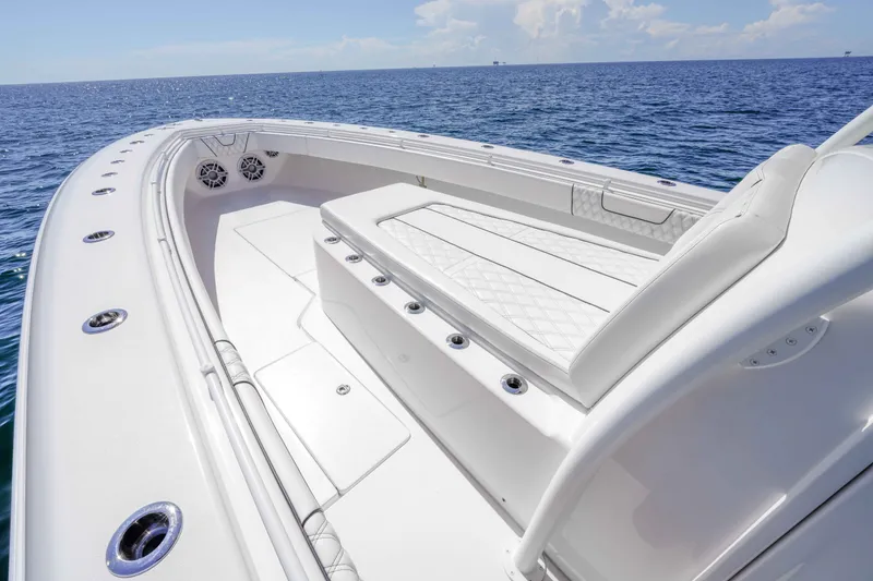 Slide: The Image of 2024 Contender 44 CB boat with spacious deck and luxurious seating on open sea. - 13