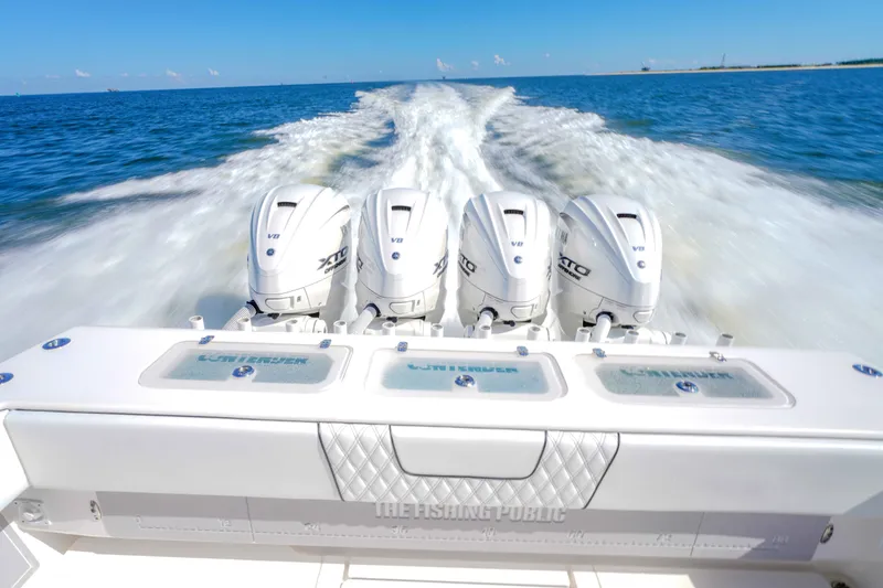 Slide: The Image of 2024 Contender 44 CB boat with four powerful outboard engines cruising on open water. - 14