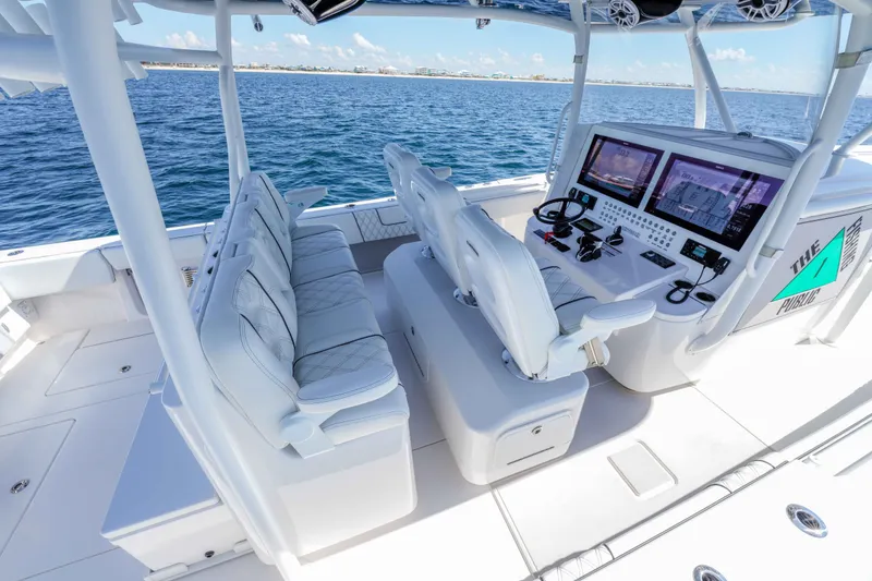 Slide: The Image of 2024 Contender 44 CB boat interior with advanced navigation system and luxurious seating. - 23