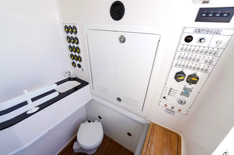 Slide: The Image of 2024 Contender 44 CB boat interior with control panel, sink, and toilet. - 29