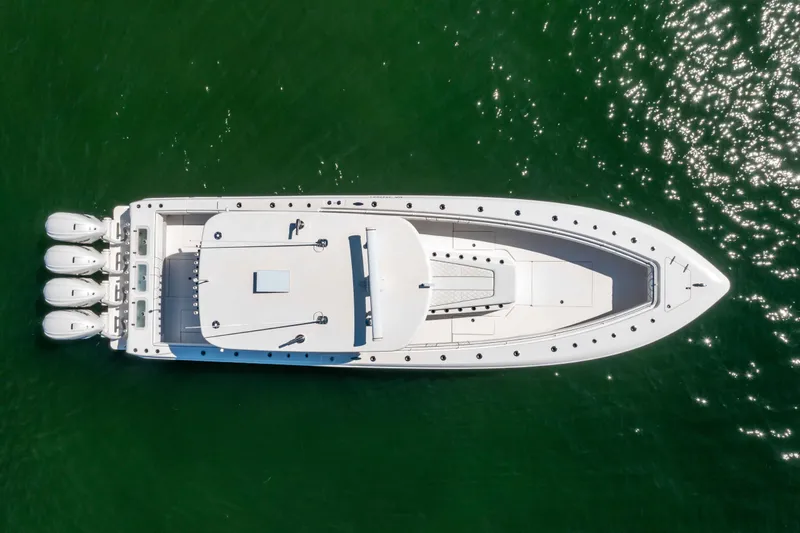 Slide: The Image of Top view of 2024 Contender 44 CB boat with four engines on green water. - 5