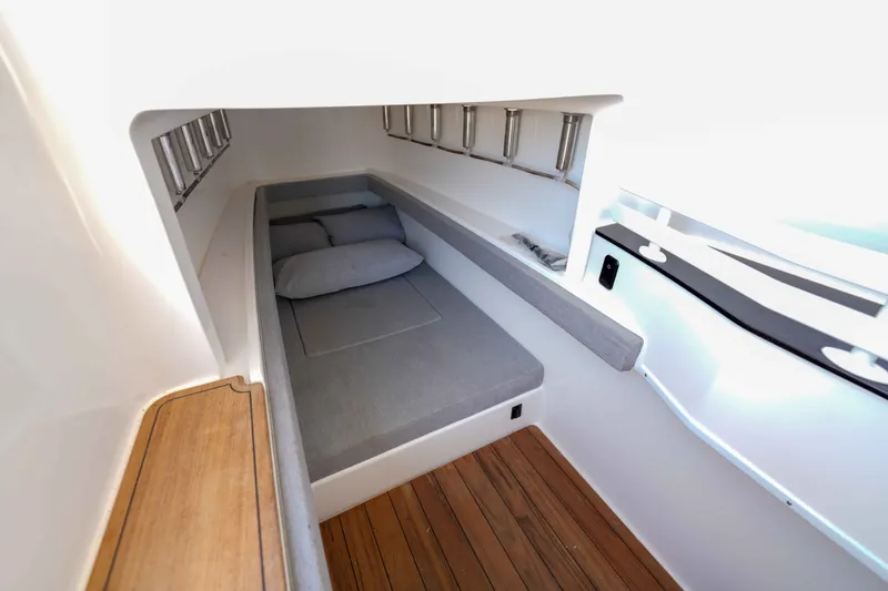Slide: The Image of 2024 Contender 44 CB cabin interior with cozy bed and wooden flooring. - 27