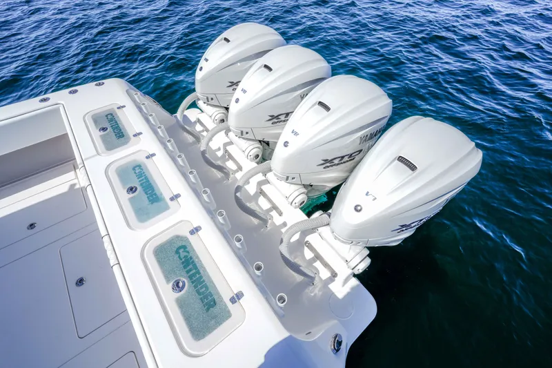 Slide: The Image of 2024 Contender 44 CB boat with four Yamaha outboard engines on open water. - 25