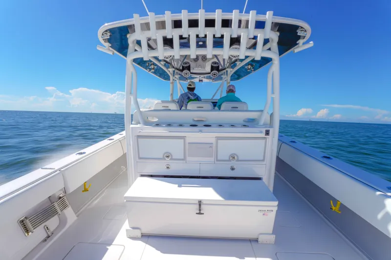 Slide: The Image of 2024 Contender 44 CB boat on open water, featuring spacious deck and modern helm. - 15