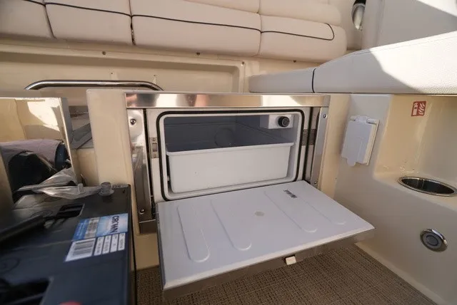Slide: The Image of An open refrigerator in a boat with beige interior and stainless steel accents. - 19