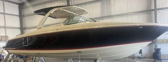 Slide: The Image of A sleek 2026 Chris-Craft Launch 35 GT Sterndrive boat in a storage facility. - 6