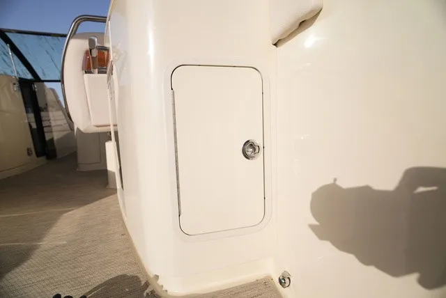Slide: The Image of Interior view of a Chris-Craft Launch 35 GT Sterdrive with white storage compartment and seating area. - 27