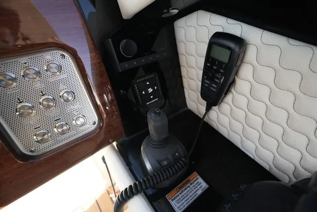 Slide: The Image of Close-up of the helm area with controls and a radio. - 35