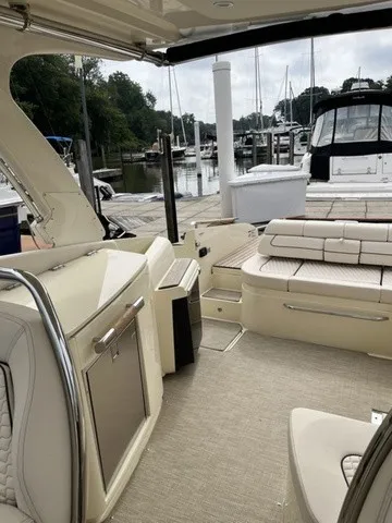 Slide: The Image of The image shows the cockpit of a Chris-Craft Launch 35 GT Sterdrive. It features elegant seating and a well-equipped galley. - 14
