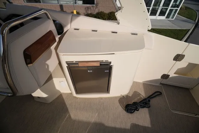 Slide: The Image of Interior of a Chris-Craft Launch 35 GT Sterdrive with a fridge and seating area. - 24