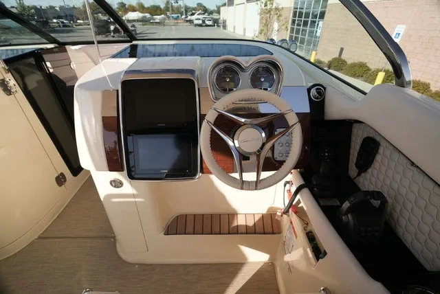 Slide: The Image of The cockpit of a 2026 Chris-Craft Launch 35 GT Sterdrive with a modern steering wheel and instruments. - 32