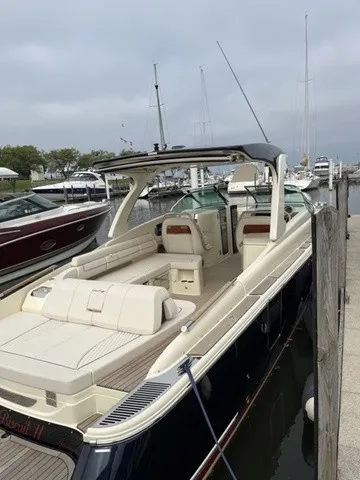 The Image of A sleek 2026 Chris-Craft Launch 35 GT Sterndrive boat docked at a marina. - 3