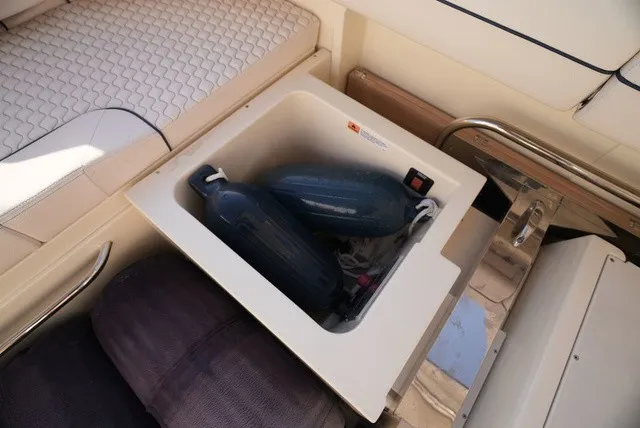 Slide: The Image of A storage compartment on a Chris-Craft Launch 35 GT Sterndrive boat with fenders and ropes. - 18