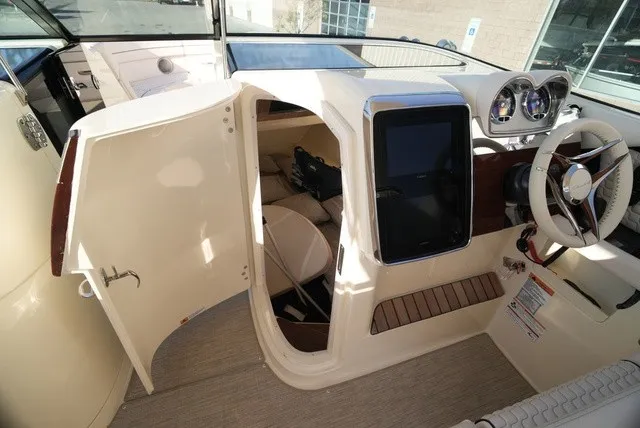 Slide: The Image of The cockpit of a 2026 Chris-Craft Launch 35 GT Sterdrive with modern instruments and a helm station. - 38