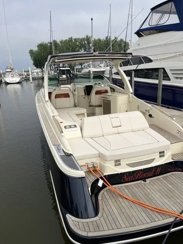 Slide: The Image of A sleek 2026 Chris-Craft Launch 35 GT Sterdrive boat docked in a marina, surrounded by other boats. - 5