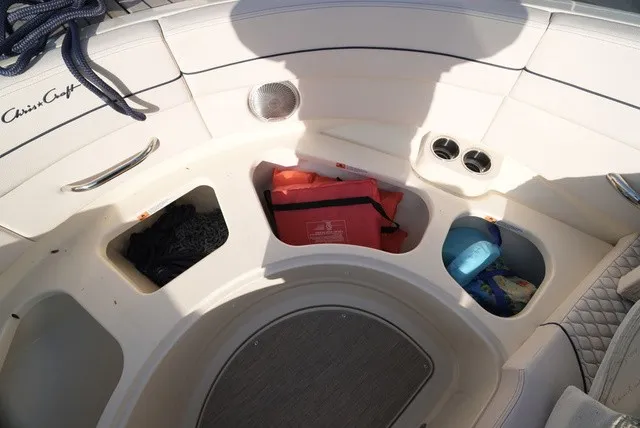 Slide: The Image of The image shows the seating area of a Chris-Craft Launch 35 GT Sterdrive with storage and accessories. - 49
