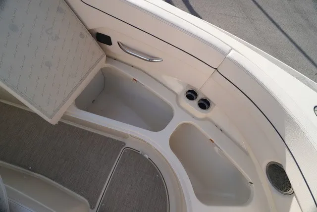 Slide: The Image of The image shows the interior of a Chris-Craft Launch 35 GT Sterdrive with beige upholstery and cup holders. - 48