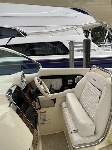 Slide: The Image of The image shows the cockpit of a Chris-Craft Launch 35 GT Sterdrive with luxurious white seating. - 9