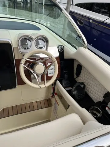 Slide: The Image of The cockpit of a 2026 Chris-Craft Launch 35 GT Sterdrive with sleek controls and leather seating. - 2