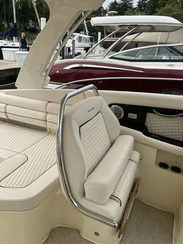 Slide: The Image of The image shows the luxurious cockpit of a Chris-Craft Launch 35 GT Sterdrive with elegant cream upholstery. - 13
