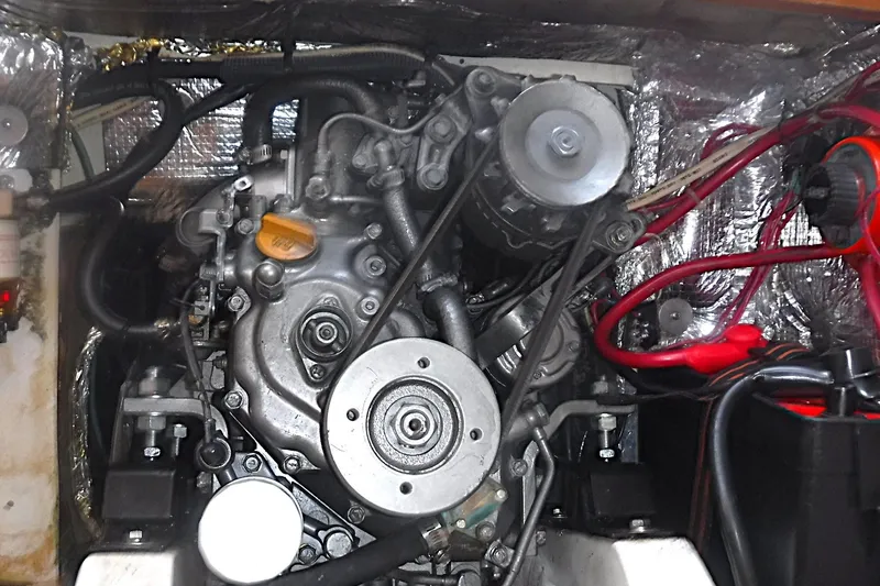 Slide: The Image of Engine compartment of a 1997 Alerion Express 28 sailboat, showcasing mechanical components and wiring. - 35