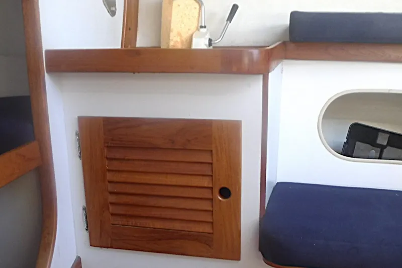 Slide: The Image of Interior of a 1997 Alerion Express 28 sailboat with wooden cabinetry and seating. - 39