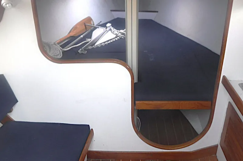 Slide: The Image of Interior cabin of a 1997 Alerion Express 28 sailboat with blue cushions and anchor. - 50