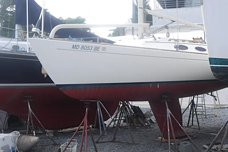 Slide: The Image of 1997 Alerion Express 28 sailboat on stands, hull number MD 8053 BE, in a boatyard. - 3