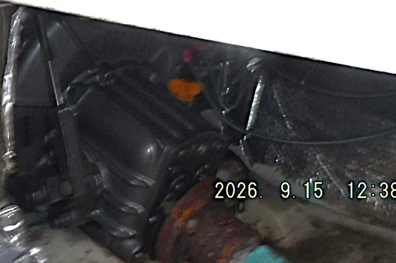 Slide: The Image of Engine compartment of a 1997 Alerion Express 28 sailboat, showing mechanical components. - 36
